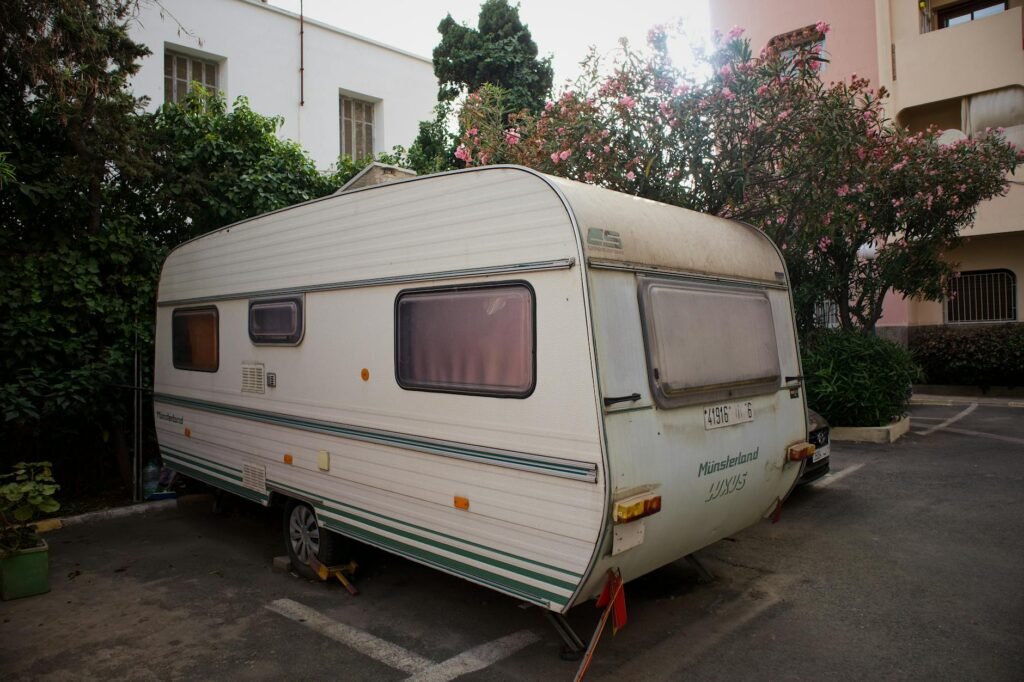 Drop-down bed hydraulic mechanism mounted to motorhome ceiling in raised position showing clearance