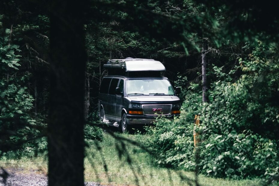 White motorhome and caravan parked side by side in UK countryside campsite for comparison