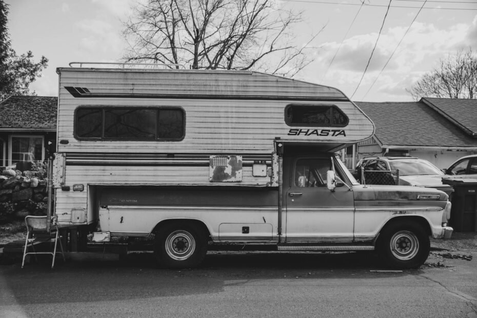 Three year old motorhome on dealer forecourt next to new model showing price comparison